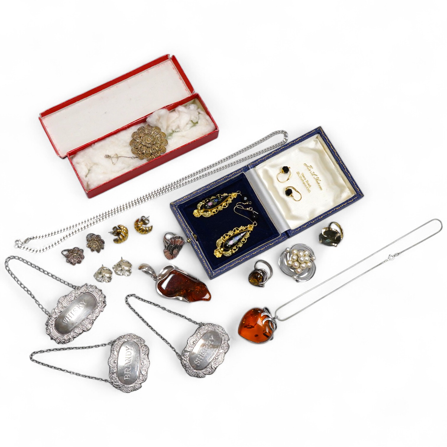 A collection of jewels, comprising: two amber pendants and an amber ring, each mounted in silver; a pair of gilt metal and enamel earrings of floral design; a pair of gilt metal earrings; a silver and cultured brooch; a